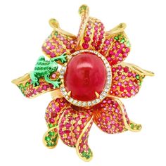 A large and impressive cocktail ring featuring a jelly-red cabochon ruby weighing 13.96 carats. It is complemented by a halo of round brilliant-cut diamonds weighing 0.22 carats. Adding to that, the ring is set with 5.17 carats of round rubies and 1.77 carats of bright green tsavorite garnets. The ring is made in a floral style with a cute little frog sitting atop which is covered in green lacquer. Made in 18k rose gold and ready to be worn Ring Size 6.75 Weight: 24.8 grams Luxury Tsavorite Round Ring, Green Lacquer, Cabochon Ruby, Rose Gold Quartz, Garnet And Gold, Platinum Diamond Rings, Tsavorite Garnet, Gold Cocktail Ring, Gold Cocktail