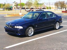 a blue car parked in a parking lot