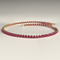 Enhance your style with this stunning Natural Ruby Tennis Bracelet. Handcrafted with care in 14K Gold, this custom stacking bracelet is perfect for July birthdays. Personalize your jewelry collection with this unique piece, or gift it to someone special during Christmas. 𝐅𝐞𝐚𝐭𝐮𝐫𝐞𝐬: * 𝐌𝐚𝐝𝐞 𝐭𝐨 𝐎𝐫𝐝𝐞𝐫 * 𝐌𝐞𝐭𝐚𝐥: 𝟏𝟒𝐊 * 𝐁𝐚𝐧𝐝 𝐂𝐨𝐥𝐨𝐫𝐬: Rose Gold, Yellow Gold & White Gold * 𝐂𝐮𝐬𝐭𝐨𝐦 𝐂𝐫𝐨𝐜𝐨𝐝𝐢𝐥𝐞 𝐋𝐨𝐜𝐤 𝐒𝐭𝐨𝐧𝐞: * 𝐒𝐭𝐨𝐧𝐞 - Natural Ruby * 𝐒𝐡𝐚𝐩𝐞 - Round Cut * 𝐒𝐢𝐳𝐞 - 1.70 MM * 𝐂𝐚𝐫𝐚𝐭 𝐖𝐞𝐢𝐠𝐡𝐭 - 1.82 Carats (Varies with Bracelet Size) * 𝐏𝐢𝐞𝐜𝐞𝐬 - 82 Pieces (Varies with Bracelet Size) * 𝐂𝐨𝐥𝐨𝐫 - Pinkish Red * 𝐂𝐥𝐚𝐫𝐢𝐭𝐲 - VVS-VS ★ 𝐍𝐚𝐭𝐮𝐫𝐚𝐥 𝐌𝐢𝐧𝐞𝐝 & 𝐄𝐭𝐡𝐢𝐜𝐚𝐥𝐥𝐲 𝐒𝐨𝐮𝐫𝐜𝐞𝐝 𝐆𝐞𝐦𝐬𝐭𝐨𝐧𝐞★ 𝐍𝐨𝐭𝐞𝐬: * Stacked Wedding Rings, Ruby Bracelet, Pinkish Red, Birthstone Bracelet, Customized Jewelry, Band Bracelet, Birthstone Bracelets, Engagement Rings Oval, Perfect Birthday Gift