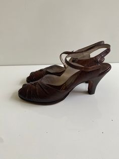 "Vintage 1950s Palizzio New York Leather Sandals Free Shipping These vintage heeled sandals are leather uppers. They are in good vintage condition and have new heel tops and new leather soles. They are tiny. The sole on the inside is just under 9.5\" long and the ball of the foot is 3\" across. The surface of the leather is embossed and could be reptile skin. The brand is Palizzio New York.  I believe them to be a size 6 or 6.5."