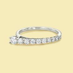 a white gold wedding band with five diamonds on top and bottom, set in 18k white gold