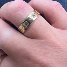 a close up of a person wearing a gold ring