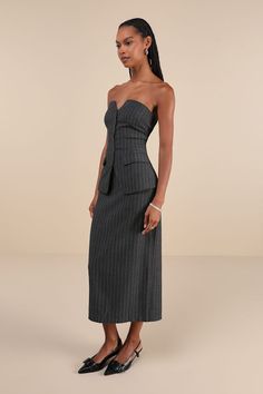 Everyone will take notice when you're dressed to the nines in the Moon River Composed Style Grey Pinstriped Strapless Vest Midi Dress! Chic, suiting-inspired woven fabric boasts a pinstriped design as it shapes a strapless bodice with a subtle, notched sweetheart neckline. Functional button placket secures at the front, creating a vest silhouette as it runs between two functional flap pockets to rounded, vest-like hems. Attached skirt has a figure-skimming silhouette and finishes at a midi hem w Striped Fitted Midi Dress For Date Night, Chic Striped Fitted Midi Dress, Fitted Pinstripe Sleeveless Dress, Fitted Sleeveless Pinstripe Dress, Striped Strapless Dress For Party, Striped Strapless Party Dress, Striped Fitted Dress For Evening, Striped Fitted Evening Dress, Fitted Strapless Midi Dress For Work