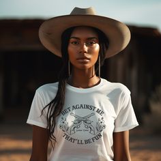 Bet Against Me That'll Be Fun Pistols t-shirt for country girls and cowgirls is a Next Level brand tee and comes in unisex cut and sizes. This graphic tee features guns and roses so to speak with its six-shooter pistols crossed in the center and pretty dainty flowers on each side. Cowgirls have a soft side until you cross them, right? This graphic tee for cowgirls is a personal favorite since my daddy called me Annie Oakley growing up. A vintage style graphic for the modern cowgirl. Looks perfec Six Shooter, Nashville Bachelorette Party, Annie Oakley, Modern Cowgirl, Dainty Flowers, Nashville Bachelorette, Party Music, Country Girls, Bourbon