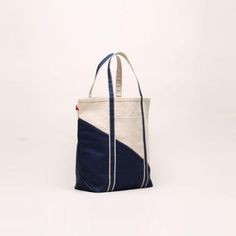 *Available for US customers only* Grab your keys, tickets, beach pass, and this great Contemporary Boat Bag! No matter where your travels take you, you can be fully prepared with all your essentials packed away in this classic navy striped tote. Perfect for air travel, road trips, sailing, train rides, amusement parks, beach days, hotel stays, pool days, lakeside afternoons, and family vacations. Artisan's Description: Our signatures with a twist of the contemporary diagonal sail design! Nothing Canvas Beach Bag With Removable Pouch For Travel, Blue Bags For Weekend Trips, Blue Bags For Weekend Trips In Summer, Functional Navy Rectangular Bags, Functional Navy Rectangular Bag, Navy Bag With Zipper Pocket For Daily Use, Navy Bags With Zipper Pocket For Daily Use, Navy Rectangular Functional Bag, Navy Shoulder Bag With Luggage Sleeve For Daily Use