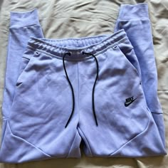 Lavender Purple Nike Tech Pants Casual Lavender Pants With Pockets, Lavender Cotton Bottoms With Pockets, Purple Sweatpants With Pockets For Spring, Spring Purple Sweatpants With Pockets, Lavender Cotton Pants For Loungewear, Lavender Cotton Lounge Pants, Lavender Cotton Loungewear Pants, Casual Fitted Lavender Pants, Lavender Pants For Spring Loungewear