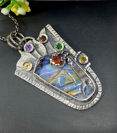 "Carved Australian Opal gemstone pendant necklace in sterling silver Hand-made Sterling Silver 925. Stones used: Australian Opal, Citrine, Amethyst, Garnet, Chrome Diopside Height - 2 1/4\" (with bail), Width - 1 1/4\" Chain length 20 inches Unique Handcrafted One-of a-kind Design Pendant Each Piece of Jewelry in my Collection is Absolutely One of a Kind! When you start wearing a piece of my jewelry you will fall in love with it more and more each day and feel that good Energy and Love that I pa Artistic Hand Forged Sterling Silver Necklace, Unique Silver Necklace With Rectangular Pendant, Artisan Sterling Silver Necklace For Gift, Fusion Style Multi-stone Necklace Gift, Fusion Style Multi-stone Necklace For Gift, Artisan Silver Necklace For Gift, Fusion Multi-stone Necklace For Gift, Artisan Multi-stone Necklaces For Gifts, Unique Sterling Silver Necklace With Rectangular Pendant