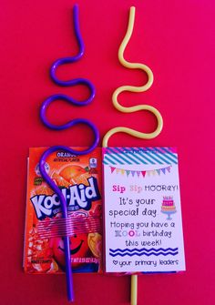 a candy bar and lollipop sticks on a pink background