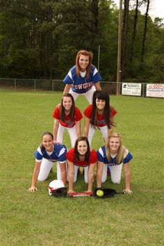 a softball team posing for a photo on the field