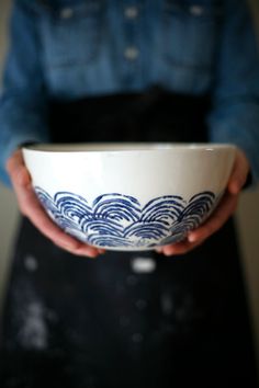 a person holding a bowl in their hands