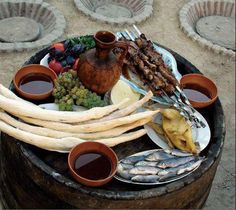 an assortment of food sitting on top of a barrel