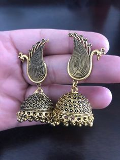 Be unique and make an impact by looking stunning with this antique oxidized peacock earrings with hanging jhumkis made with love💕 for someone special! In stock and ready to ship. Hand crafted and gold plated kundan indian/pakistani jewelry Material:brass,stone,gemstone,pearl We bring you casual as well as party wear jewelry which comes with an attractive design and style. It goes well modern and traditional outfits. Visit my website for more collections https://www.etsy.com/shop/Noorzaracollect Antique Chandbali Earrings For Festivals, Traditional Oxidized Jhumkas Drop Earrings, Traditional Oxidized Finish Jhumkas Drop Earrings, Traditional Oxidized Drop Earrings Jhumkas, Diwali Oxidized Finish Drop Jhumkas, Festival Gold Jhumkas With Latkans, Diwali Oxidized Drop Jhumkas, Gold Jhumkas With Latkans For Festival, Gift Brass Jhumkas With Latkans