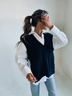 DETAILS: Our Knitted Oversized Vest has a soft and cozy knitted fabric that has an oversized fit. There is a deep v neckline that is outlined with a ribbed look. There is also a ribbed look on the hem and around the opening for the arms. There are two side slits for an open look. This vest does have an oversized look but fits true to size and our model is wearing a small! CONTENT & CARE: SELF: 42% Acrylic, 30% Polyester, 28% Nylon. SIZE & FIT: Model is 5'6" The model is wearing a size Small. Fit Knit Vest Aesthetic, Oversize Knit Vest, Styling An Oversized Sweater Vest, Knitted Vest Dress Outfit, Oversize Sweater Vest, Sweater Vest Outfit Oversized, Casual Chunky Knit V-neck Sweater For Layering, Business Vest Outfits, Ribbed V-neck Knit Top For Layering