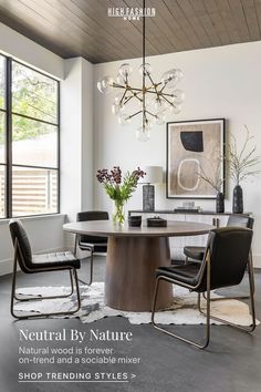 a dining room table with two chairs and a chandelier hanging from the ceiling