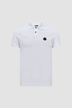 A timeless design that transcends seasons, this polo shirt is crafted from cotton piqué. The classic style is embellished with a Moncler logo patch on the chest. Luxury Polo Shirt With Ribbed Collar, Luxury Polo Shirt With Ribbed Collar And Short Sleeves, Luxury Short Sleeve Polo Shirt With Ribbed Collar, Classic White Polo Shirt With Embroidered Logo, Luxury Short Sleeve Polo Shirt, Designer Polo Shirt With Embroidered Logo, Designer Cotton Polo Shirt, Luxury White Short Sleeve Polo Shirt, Luxury Cotton Short Sleeve Polo Shirt