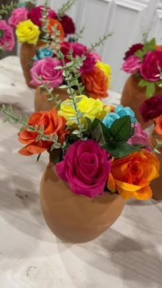 several vases filled with different colored flowers on a table