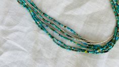 "5 gorgeous strands of hand hewn tiny natural turquoise beads and three strands of miniscule sterling silver beads from the Karen Hill Tribe of Thailand . Approx 17\" long" Honey Colour, Choker Necklaces, Jade Pendant, Natural Turquoise, Silk Ribbon, Turquoise Beads, Sterling Silver Bead, Multi Strand, Silver Beads