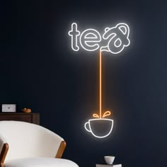 a neon sign that says tea with a coffee cup on it