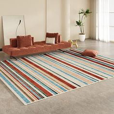 a living room filled with furniture and a striped rug