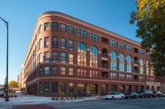 a large brick building with lots of windows on the side of it's face