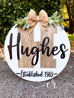 a wooden sign that says highes established 1933 and has a bow on it