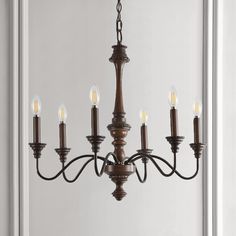 Based on historic wrought iron chandeliers, our rustic 6-light design features a quality wood-look finish. Perfectly sized for a farmhouse dining room, tall entry, or kitchen with high ceilings, our chandelier is just 25" wide and features tall candles with LED candle bulbs. Use this versatile chandelier in a modern farmhouse, French country or Tuscan style home, or to add character to a rustic, industrial space. JONATHAN Y Oakley 25" Rustic 6-Light Oil-Rubbed Black Farmhouse Bare Bulb Chandelie Midcentury Farmhouse, Kitchen With High Ceilings, Bulb Chandelier, Tuscan Style Homes, Black Farmhouse, Wrought Iron Chandeliers, Tall Candle, Iron Chandeliers, Tuscan Style