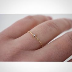 14k Yellow Gold Tiny Diamond Ring, Diamond Ring with thin band, Dainty Diamond Ring, diamond engagement ring, Diamond stack ring, thin  Diamonds : This is a beautiful 1.75mm (.02ct weight) round full facet diamond. The diamond is Bezel set in 14kt yellow gold.  ✦Gemstone: genuine diamond  ✦Stone Cut: round brilliant cut ✦Stone Size: 1.75mm ✦Metal: solid 14K gold .8mm  This band is perfect for stacking, and looks beautiful on its own.  Jenhoughdesigns.etsy.com Minimalist Gold Diamond Ring, Engagement Rings Petite, Golden Diamond Ring, Tiny Diamond Ring, Delicate Gold Ring, Square Engagement Rings, Slim Ring, Yellow Diamond Engagement Ring, Dainty Diamond Ring