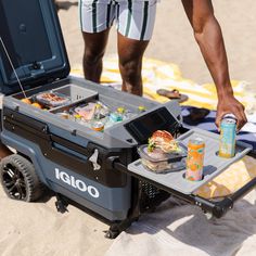 a cooler with food and drinks on the beach