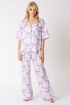 Light purple satin pajama pants with dark purple bow tie print You'll have the Sweetest Dreams in these purple satin pajama pants! Featuring a light purple satin fabric with dark purple bow tie print, an elastic waistband, front pockets, and wide legs with dark purple trimmed cuffs. Perfect for bedtime, or comfy lounging. Grab the matching top and get ready to trend while your sleep! Fits true to size; relaxed silhouette Fabric contains stretch Model is wearing a small Elastic waistband Front po Purple Pajama Pants, Sleep Fits, Purple Pajamas, Satin Pajama Pants, Sweetest Dreams, Purple Bow Tie, Purple Trim, Purple Bow, Satin Pajama