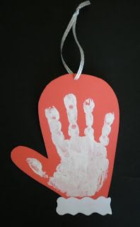 a handprinted ornament is hanging on a black background with an orange tag