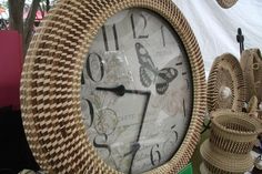 a clock that is sitting on top of a table next to some baskets and other items