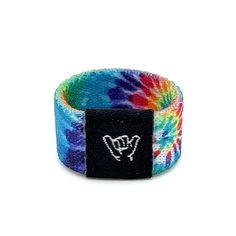 Hang Loose with this trippy tie dye band. Festivals, shows, concerts...wherever your journey takes you, embrace the moment and send good vibes with our most popular band. One size Fits fingers size 6 to 8. 1/2" Width Reversible surf and beachy prints. Elastic blend material. Packaged in natural drawstring gift pouches. Machine washable. Chlorine and saltwater safe. Rave Jewelry For Music Festival With Adjustable Fit, Adjustable Multicolor Rave Wristband, Adjustable Multicolor Jewelry For Music Festival, Casual Multicolor Wristband, Beachy Prints, Popular Bands, Sending Good Vibes, Hang Loose, Good Vibes