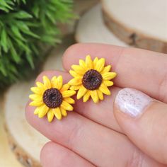 This Sunflower Earrings is the prettiest, one of a kind jewelry that you have been looking for! If you want to have a beautiful yellow flower earrings, or just searching for the perfect gift for girls, or bridesmaids, then you have came to the right place! D E T A I L S: * Handmade Sunflower Stud Earrings * Made from Polymer Clay * Width: 0.7 inches (1.8 cm) * Earring posts: Stainless steel * Earrings are light and easy to wear * Earrings arrive nicely packed in a eco friendly box You can also a Yellow Sunflower Design Earrings For Gift, Yellow Sunflower Design Earrings Gift, Yellow Flower Shaped Jewelry With Sunflower Print, Yellow Flower-shaped Jewelry With Sunflower Print, Yellow Sunflower Design Earrings For Summer, Summer Flower Earrings With Sunflower Design, Summer Sunflower Design Earrings, Summer Sunflower Design Flower Earrings, Adjustable Sunflower Design Earrings For Summer