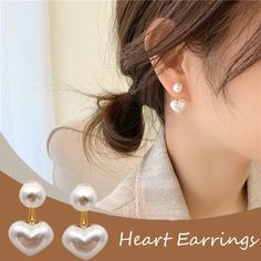 Introducing our exquisite collection of pearl and heart earrings! These charming accessories feature a timeless golden base color adorned with delicate heart-shaped patterns. Crafted to perfection, these small earrings add a touch of Korean-inspired elegance to any outfit. The lustrous pearls bring a classic sophistication, making them perfect for parties or special occasions. Whether you're drawn to the whimsical allure of heart earrings or the timeless beauty of pearl earrings, our collection White Heart-shaped Pearl Earrings For Party, Heart-shaped Pearl Earrings For Gifts, Pearl Heart-shaped Earrings For Gifts, White Heart-shaped Earrings With Pearl Charm, Elegant Heart-shaped Pearl Earrings For Valentine's Day, Golden Earrings, Ear Stud, Cute Heart, White Earrings