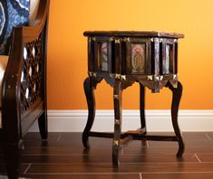 a small wooden table sitting on top of a hard wood floor