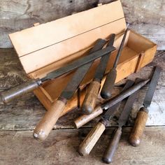 a wooden box filled with lots of different types of knives