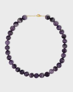 This delicate necklace features a polished Chevron Amethyst sphere hand strung and finished with 14k gold chain. Chevron Amethyst is known for its calming properties and beautiful violet hues. The smooth, polished sphere adds a touch of sophistication to the piece. This necklace is handcrafted in NYC and is a perfect everyday piece that adds a touch of natural beauty and serenity. Chevron Amethyst 14 Karat Gold 16 to 17.5 inches Handmade in NYC Classic Amethyst Purple Necklace, Classic Purple Amethyst Necklace, Classic Amethyst Necklace For Gift, Spiritual Yellow Gold Amethyst Necklace, Yellow Gold Amethyst Round Pendant Necklace, Elegant Lavender Necklaces With Natural Stones, Faceted Amethyst Healing Necklace, Elegant Amethyst Beaded Necklaces For Healing, Elegant Amethyst Beaded Necklace For Healing