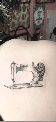 a tattoo with a sewing machine on it