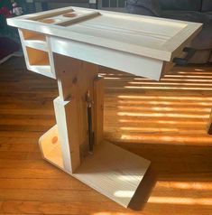 a wooden table sitting on top of a hard wood floor