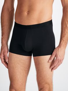 Our Alex boxer briefs in black are cut for a streamlined, classic look with a fitted shape, closed front and a shorter leg. A fabric-covered waistband provides gentle skin contact. Crafted from a lighter weight version of our best-selling Basel fabric, combining a blend of 94% micro modal and 6% elastane for exceptional softness and comfort. Not only is the Alex boxer brief soft, but thermostatic properties in the micro modal fibres allow them to react to changes in temperature and regulate your Black Fitted Seamless Boxer Briefs, Fitted Seamless Black Boxer Briefs, Black Seamless Short Boxer Briefs, Black Seamless Short Length Boxer Briefs, Micro-elastic Short Black Boxer Briefs, Compression Boxer Briefs With Short Legs, Compressive Solid Color Boxer Briefs, Micro-elastic Short Length Black Boxer Briefs, Black Micro-elastic Multi-pack Boxer Briefs