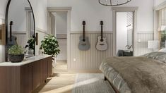 a bed room with a neatly made bed and guitars on the wall