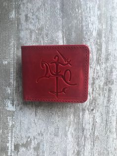 100 % full-grain handmade leather wallet. Slim and small red bifold wallet for men. Precisely made from high quality cow leather. Lasts for years, therefore is a perfect gift. The wallet is engraved with an ancient stylized coat of arms of Lithuania. Wallet is made from full grain cow leather. Crazy horse is a specially processed leather type that gives it an antique appearance. This type of leather is long lasting, very durable and any scratches or rubs turn it to a different shade, bend line a Red Leather Card Holder With Coin Pocket, Red Leather Trifold Wallet For Daily Use, Red Leather Trifold Wallet For Everyday, Red Leather Trifold Rectangular Wallet, Handmade Red Wallet For Everyday Use, Handmade Red Wallet, Red Bifold Wallet With Rfid Blocking, Burgundy Leather Wallets For Gift, Burgundy Leather Wallets As Gift