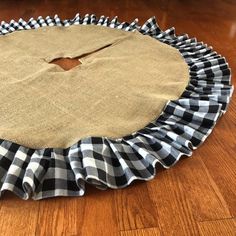 a black and white checkered cloth is on the floor with a hole in it