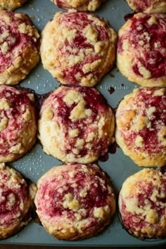 freshly baked raspberry muffins on a baking tray ready to be eaten