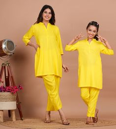 Mother's Kurta Set:-Readymade Rayon Straight Kurta in Yellow This attire is Crafted in Chinese Collar and Quarter Sleeve Available with a Rayon Palazzo in Yellow along with both side Pockets Do note: Accessories shown in the image are for presentation purposes only and length may vary upto 2 inches.(Slight variation in actual color vs. image is possible). Daughter's Kurta Set:- Readymade Rayon Short Kurti in Yellow This Chinese Collar and Quarter Sleeves Co-Ord Set attire with Lining is Enhanced Casual Yellow Sets For Festive Occasion, Casual Straight Kurta Sets For Diwali, Casual Straight Kurta Set For Festive Occasions, Festive Casual Straight Kurta Set, Casual Festive Straight Kurta Sets, Casual Yellow Kurta For Eid, Casual Festive Sets With Straight Kurta, Casual Yellow Sets For Eid, Casual Straight Kurta Set For Eid