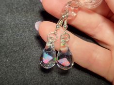 "Make a splash with these Mermaid's Tears earrings!  These gorgeous hand-blown teardrop earrings are made with only the highest quality borosilicate glass and features a mesmerizing Gilson opal polished nugget that shimmers with blue, green, yellow, and even a hint of red within the opal encased in glass. These earrings come mounted on sturdy sterling silver fish hooks, perfect for those with sensitive ears. And with a heavy gauge sterling that won't bend out of shape, you can wear these earring Nickel-free Glass Drop Jewelry, Nickel-free Teardrop Glass Jewelry, Nickel-free Glass Teardrop Jewelry, Glass Drop Earrings With Matching Set, Hypoallergenic Teardrop Glass Jewelry, Teardrop Glass Beads For Jewelry Making, Glass Teardrop Jewelry With Matching Earrings, Glass Drop Earrings As Gift, Silver Drop Glass Jewelry