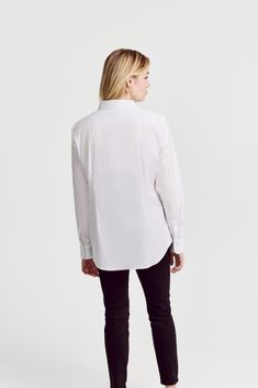 The Icon Shirt runs tailored at the waist, chest and back.  For a contemporary fit, order true size.  For a blousier fit, size up, or consider The Boyfriend Shirt for an even looser look.

 Our perfect fit cotton stretch button down. We designed our best-selling Icon Shirt to be fitted throughout, giving you a body-hugging shape yet eliminating blouse gape completely.  Our cotton stretch is sourced from a family-run mill in Spain and produced in our factory in Portugal by a local team of artisan Modern Tops With Shirttail Hem For Daywear, Modern Tops With Concealed Placket For Workwear, Modern Tops With Concealed Placket, Modern Workwear Tops With Concealed Placket, Modern Tops For Workwear With Concealed Placket, Modern Long Sleeve Tops With Concealed Placket, Modern Long Sleeve Top With Concealed Placket, Classic Button-up Tops For Daywear, Modern Tops With Spread Collar For Daywear