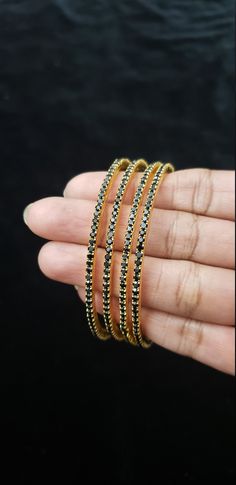 "* Handcrafted Gold Plated 4 Bangle Set. Sold as a set. * Bangles with high quality black stones. * High Quality 22K Gold Plated. Bangles Sizes : 2.4 inches= ( 2.25\" diameter of the inner circle) ; 2.6 inches = ( 2.40\" diameter of the inner circle); 2.8inches = (2.54\" diameter of the inner circle) The gorgeous gold-plated bangles set best exemplifies the careful craftsmanship done on it -- specially picked for you by Nemali Jewelry. It has a special tone of elegance attached to it. The intric Traditional Black Bracelets For Weddings, Traditional Black Bracelet For Wedding, Traditional Black Wedding Bracelets, Black Bangle Bracelets For Festive Occasions, Black Bangle For Wedding, Traditional Black Bracelets For Party, Traditional Black Party Bracelets, Festive Black Bangle Bracelet, Festive Black Bangle Bracelets