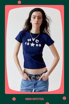 '90s baby tee vibes with this soft and stretchy cropped top complete with NYC applique at the chest. The perfect basic t-shirt is only at Urban Outfitters. Features NYC 1990 applique baby tee Soft and stretchy baby tee Raw-edge NYC applique at the chest Bodycon fit Crew neckline Short sleeve Cropped length UO exclusive Content + Care 100% Cotton Machine wash Imported Size + Fit Model in Grey is 5’10.5" and wearing size Medium Measurements taken from size Medium Chest: 28" Length: 21" | NYC 1990 Retro Cropped T-shirt With Text Print For Summer, Fitted 90s Style Crop Top T-shirt, 90s Inspired Blue T-shirt With Letter Print, 90s Inspired Logo Print Summer T-shirt, Urban Outfitters Letter Print T-shirt For Summer, Vintage Stretch Top With Letter Print, Vintage Stretch Tops With Letter Print, Vintage Stretch T-shirt For Summer, Urban Outfitters Letter Print T-shirt For Spring