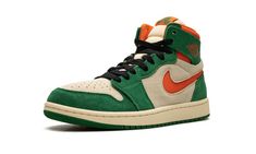 The Air Jordan 1 High Zoom CMFT 2 "Pine Green" is a colorway of the modified version of the retro basketball shoe with green and orange details.  The Jordan 1 Zoom Comfort 2 is the second version of the Jordan 1 Zoom Comfort shoe that puts a casual, more comofrtable spin on the classic silhouette.  The “Pine Green” features a Muslin suede base with Pine Green suede overlays.  An Orange Blaze cut-out Swoosh appears on the sides and a “Wings” logo is found on the collar.  “Zoom Air” branding repla Orange Details, Retro Basketball Shoes, Retro Basketball, Comfort Shoe, Wings Logo, Stadium Goods, Air Jordan 1 High, Pine Green, Jordan 1 High